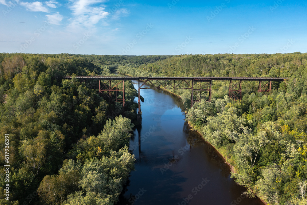 Railroad Trestle Bridge Passes Over River and Forest Railroad Trestle Bridge Passes Over River and Forest