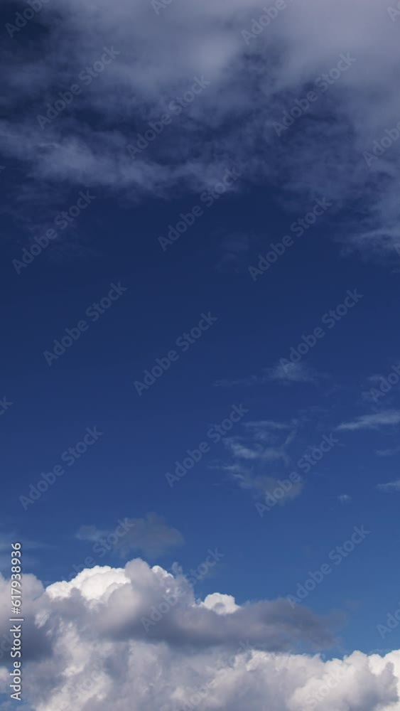 Time lapse of fluffy soft clouds run across the blue sky, cirrus and cumulus change as they move across the peaceful sky, vertically Time lapse of fluffy soft clouds run across the blue sky, cirrus and cumulus change as they move across the peaceful sky, vertically