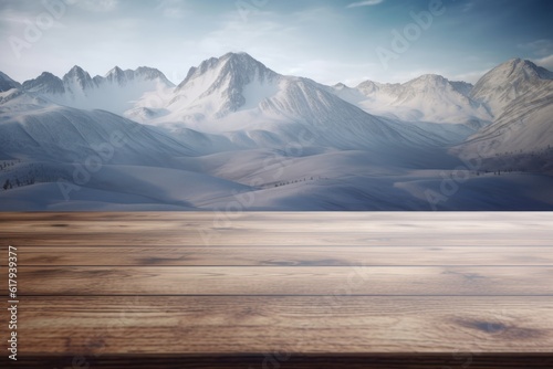 Empty brown wooden table top against winter snowy high mountains and sky
