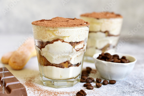 Tiramisu - traditional italian coffee dessert from mascarpone cheese and biscuit in a glass cup.