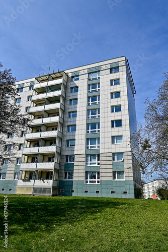 Plattenbau der DDR, Ostdeutschland, Altes Mehrfamilienwohnhaus als Hochhaus mit Balkonen bei blauem Himmel in Magdeburg, Sachsen, Deutschland photo