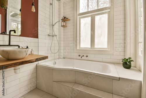 a bathroom with red walls and white tiles on the walls  along with a bathtub next to a window