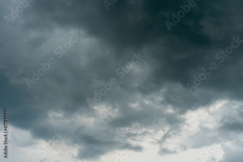Fototapeta Naklejka Na Ścianę i Meble -  A terrible black cloud hangs in the sky before the rain. Bad weather. Hurricane and thunder over the city. Climate change and natural disasters. Bad mood and despondency.