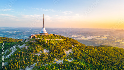 Sunny evening at Jested Mountain with unique building on the summit. Liberec, Czech Republic. Aerial view from drone. photo