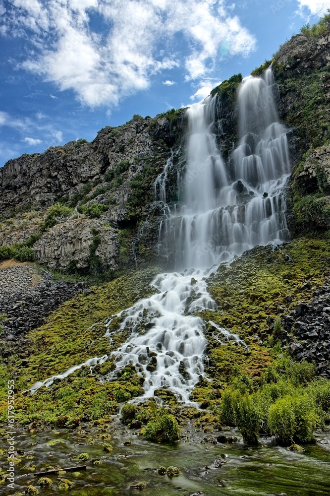 Waterfall under a blue sky in Idaho. Waterfall under a blue sky in Idaho.