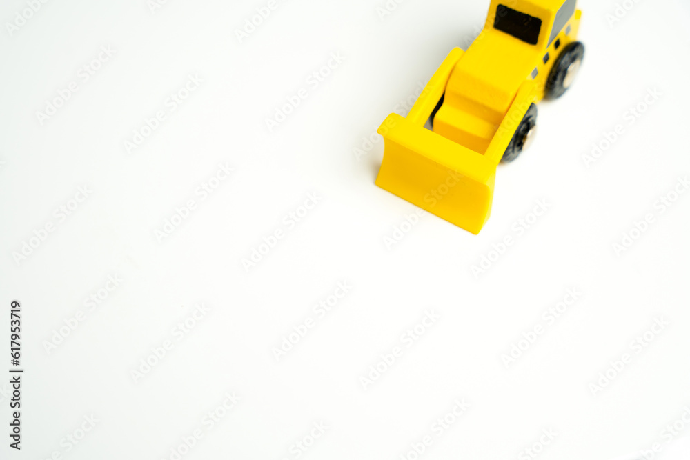 Fototapeta premium Toy yellow bulldozer and place for text on a white background. Demolition services, land leveling and other land works. Take down Illegal buildings. Industry machinery for rent