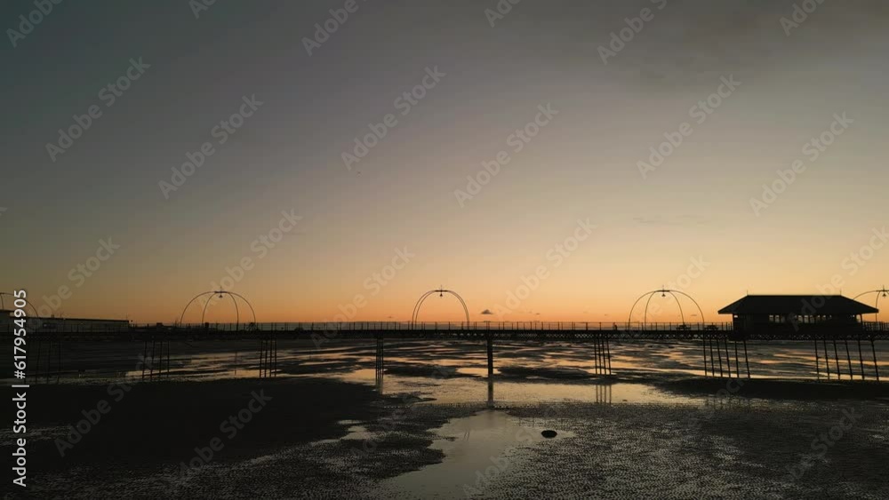 Southport, Lancashire, UK, December 8, 2022; Low aspect aerial traverse and orbital clip of the stunning sunset and Southport pier, England, UK Southport, Lancashire, UK, December 8, 2022; Low aspect aerial traverse and orbital clip of the stunning sunset and Southport pier, England, UK