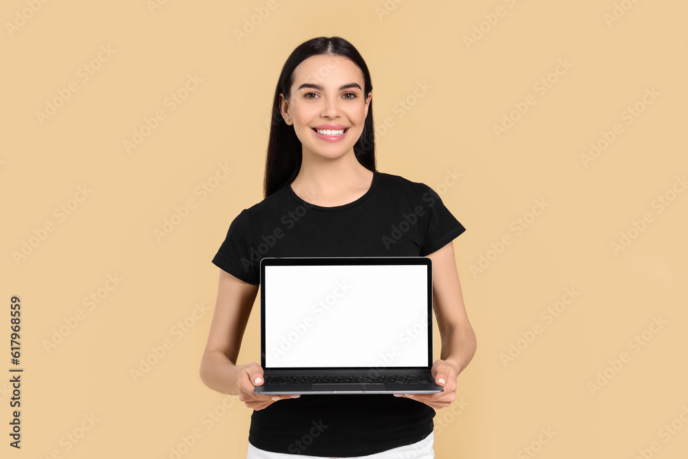 Happy woman with laptop on beige background Happy woman with laptop on beige background