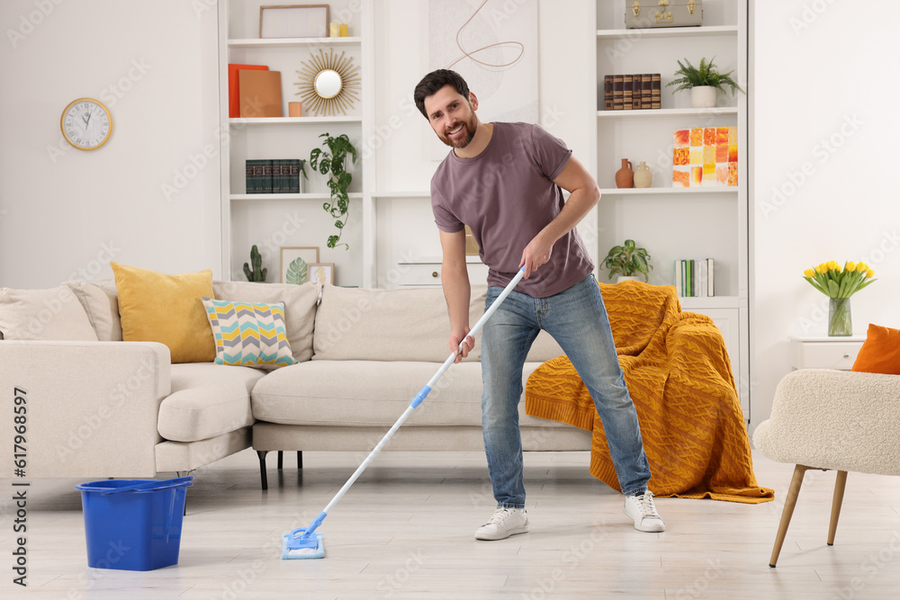 Spring cleaning. Man with mop washing floor at home Spring cleaning. Man with mop washing floor at home
