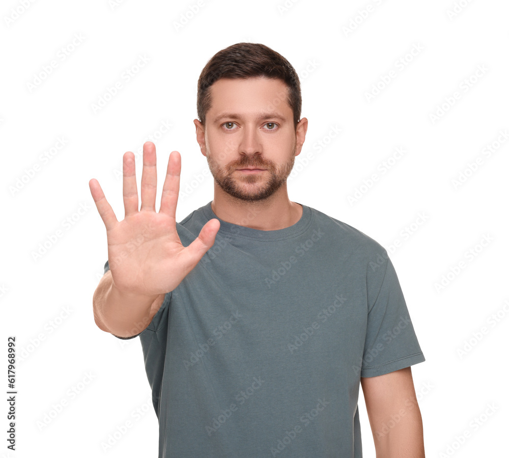 Handsome man showing stop gesture isolated on white Handsome man showing stop gesture isolated on white