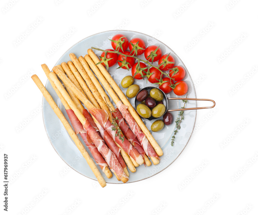 Plate of delicious grissini sticks with prosciutto, tomatoes and olives on white background, top view Plate of delicious grissini sticks with prosciutto, tomatoes and olives on white background, top view