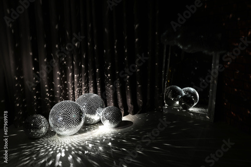 Many shiny disco balls in dark room photo