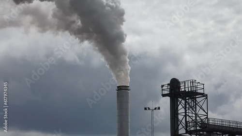 Climate Change And Global Warming caused by air pollution in big factories photo