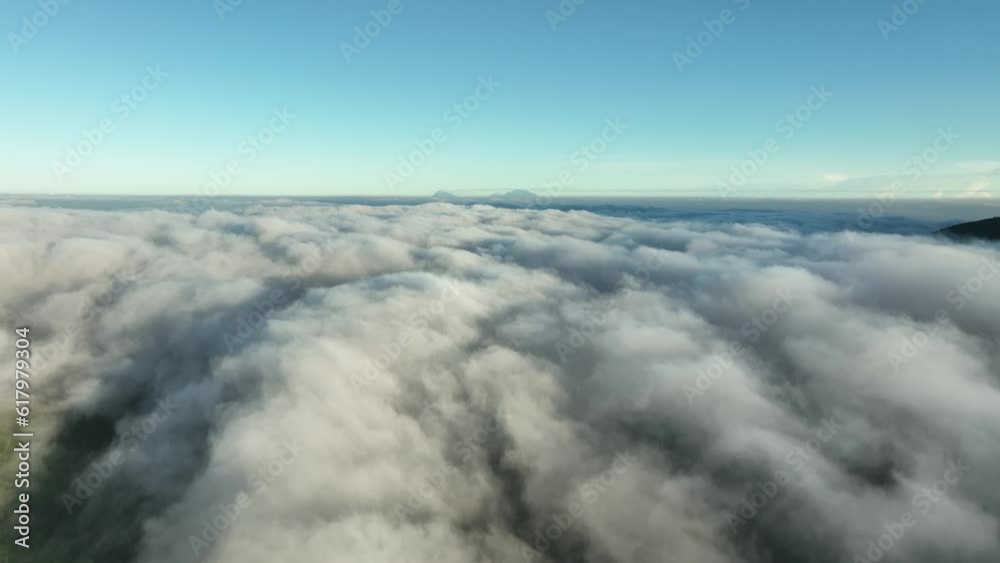 Aerial View Above Clouds and Mountains at Sunrise Aerial View Above Clouds and Mountains at Sunrise