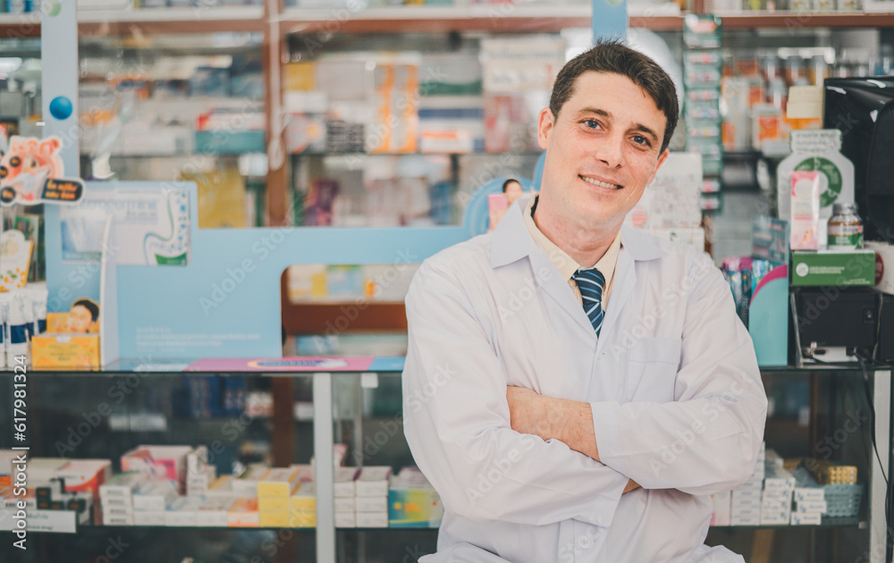 Male pharmacist posing confidently welcoming, advising patients and prescription patients in modern pharmacy.