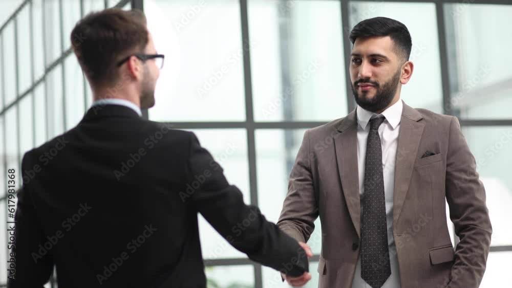men colleagues in suits are meeting in office corridor men colleagues in suits are meeting in office corridor