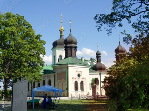 Black domes of the white church with crosses on the blue sky. KI