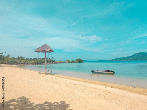 beautiful beach scenery, there are ships and swings with a bright sky background