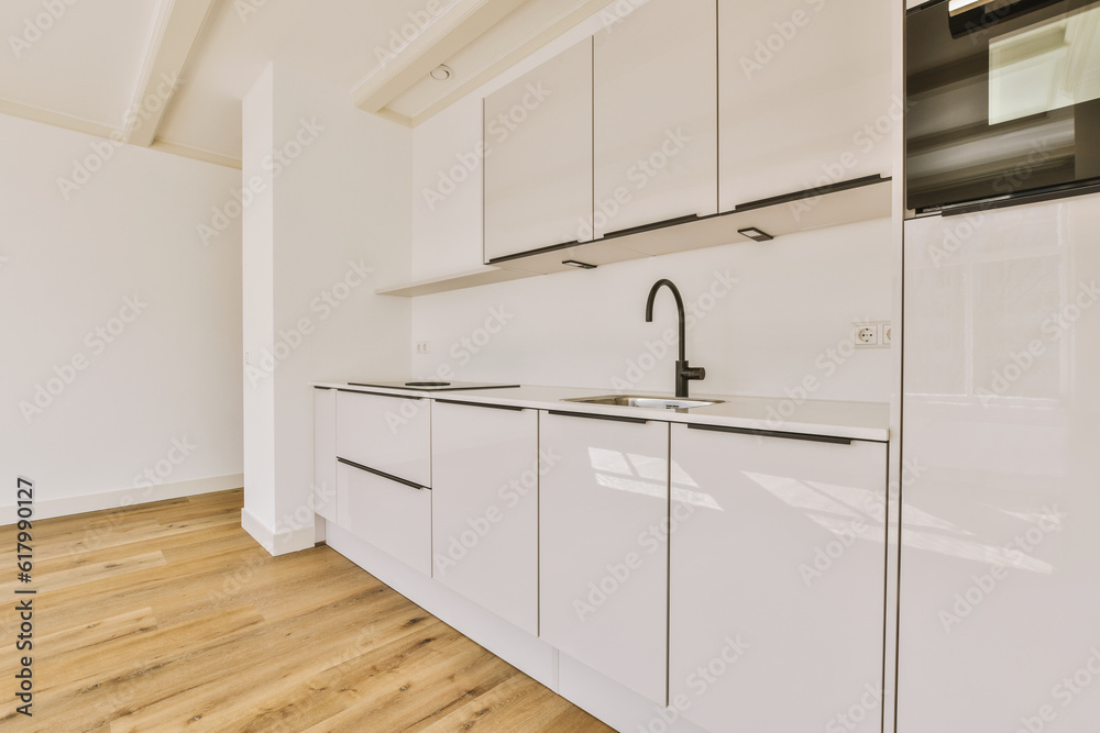 a kitchen with white cabinets and black appliances on the counters in front of the sink is empty, but there is no one a kitchen with white cabinets and black appliances on the counters in front of the sink is empty, but there is no one