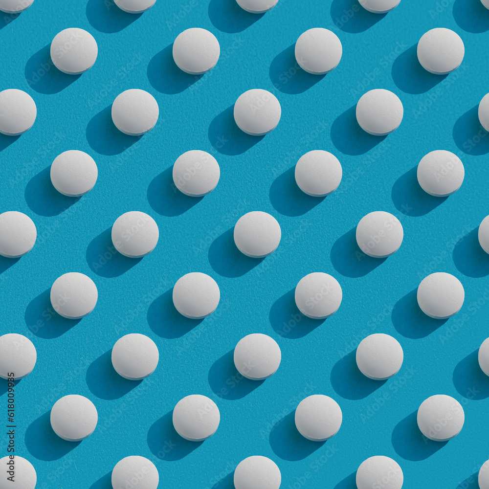 Repeating pattern of white round pills with shadow on a blue background