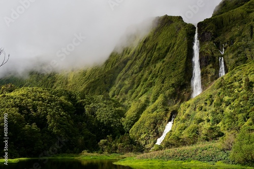 Waterfall in nature covered cliffs