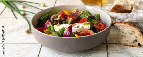 bowl with traditional greek horiatiki salad on light table photo