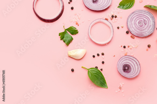 Fototapeta Naklejka Na Ścianę i Meble -  Fresh onion slices and spices on pink background