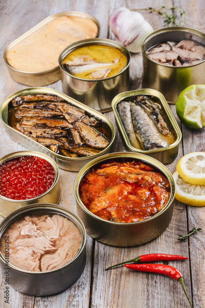Variety of opened cans with different types of tinned fish and seafood