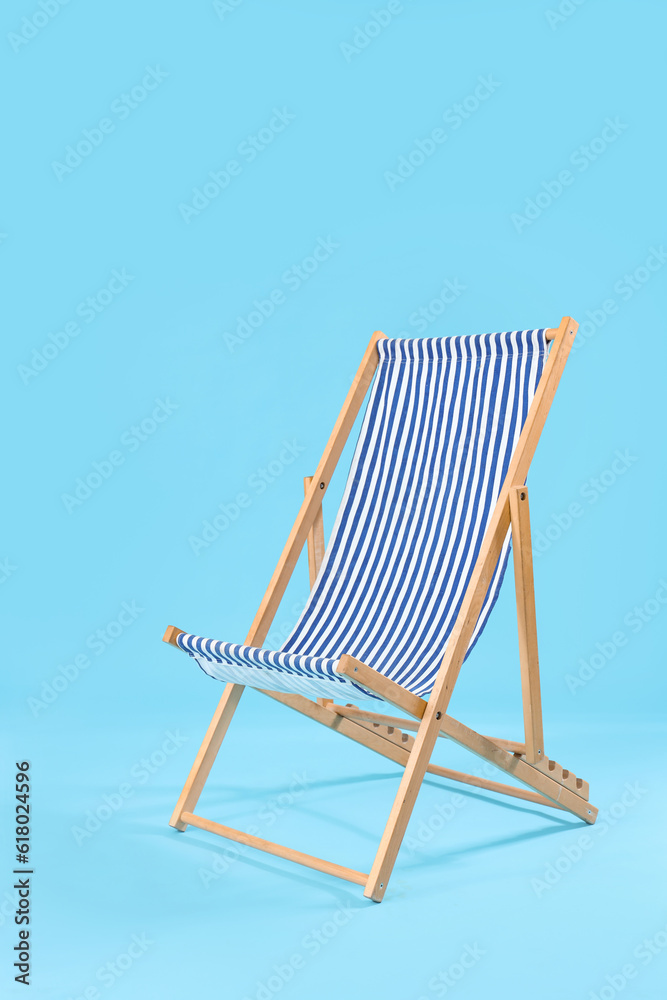 Striped deck chair on blue background