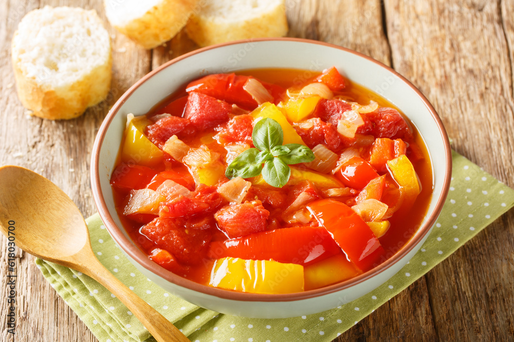 Mediterranean vegetable bell pepper stew with onions, garlic and tomatoes close-up in a bowl on the table. Horizontal Mediterranean vegetable bell pepper stew with onions, garlic and tomatoes close-up in a bowl on the table. Horizontal
