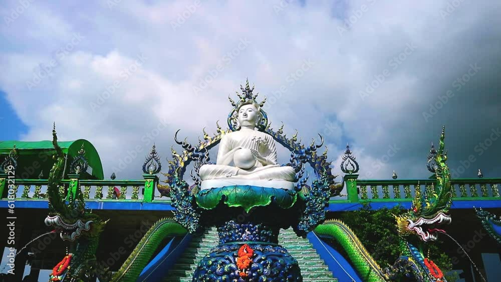 white sitting buddha dark cloud rolling background dark sky time lapse