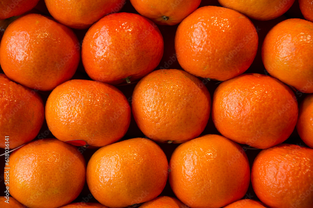 oranges displayed in a market stall oranges displayed in a market stall