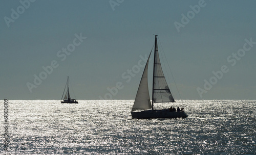 boat race on sea, sailboat in sunset