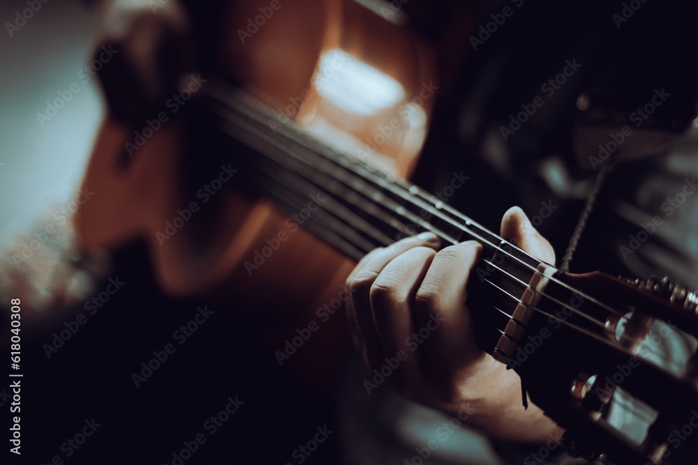 A man playing the guitar, hands and strings A man playing the guitar, hands and strings