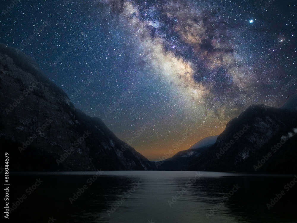 Milky Way galaxy with stars in the night sky with mountain and lake