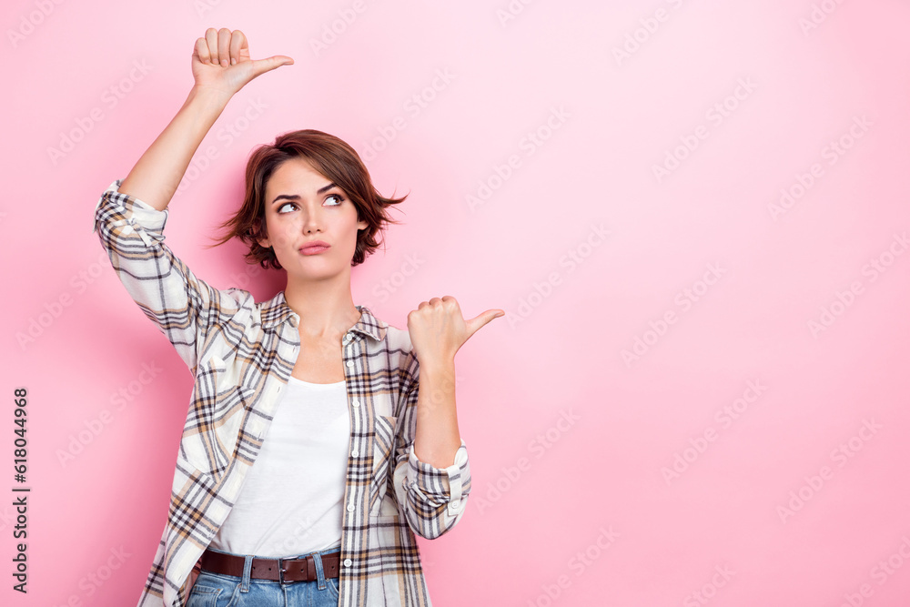 Photo of suspicious looking businesswoman doubts pointing fingers empty space uncertain about warranty isolated on pink color background