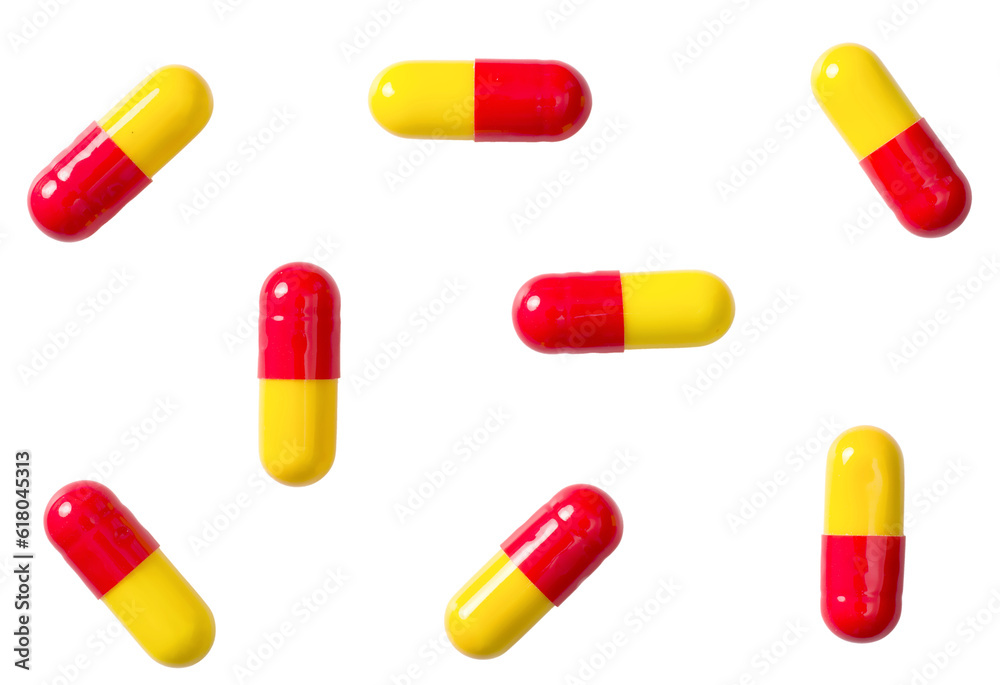 Red and yellow capsules isolated on white background, top view. Red and yellow capsules isolated on white background, top view.