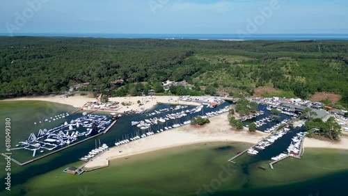Boat marina and Aquapark Biscarrosse France with slides, trampolines and climbing frames , Aerial pan left shot photo