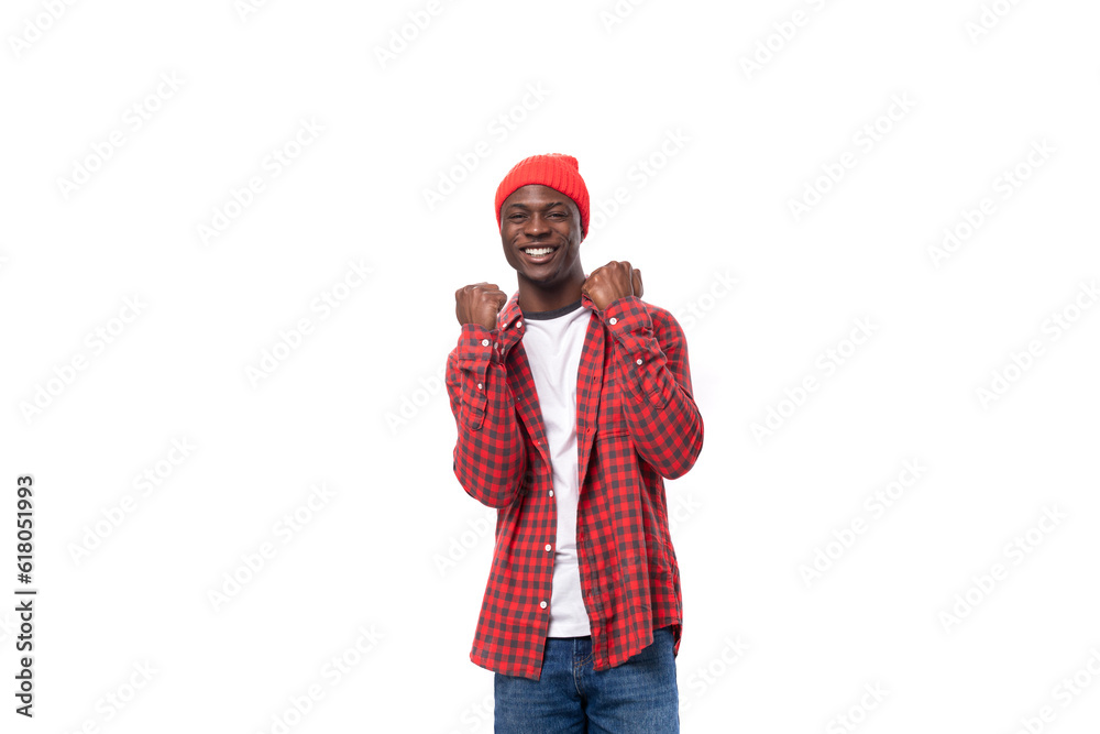 handsome joyful dark-skinned man in a casual plaid shirt of a model appearance with inspiration wants to communicate an idea on a white background with copy space handsome joyful dark-skinned man in a casual plaid shirt of a model appearance with inspiration wants to communicate an idea on a white background with copy space
