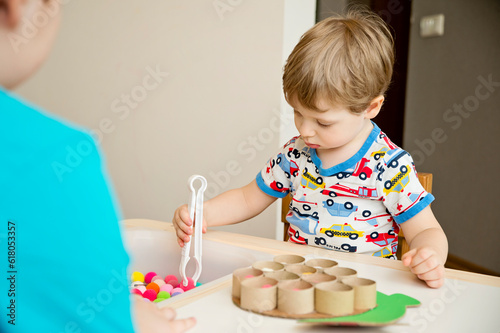 Happy turtle. Sorting game for toddlers. Fill cells with pompoms. Early education, learning colors and counting. Montessori thematic implement for preschool and special needs school