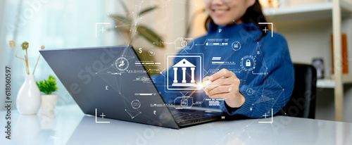 Woman using computer Laptop conducting online financial transactions through the internet. The concept of Mobile Banking or Virtual Banking technology that is convenient, emphasizing safety.