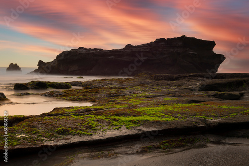 Beautiful sunrise scenery of unique rock island at atuh beach nusa penida, bali