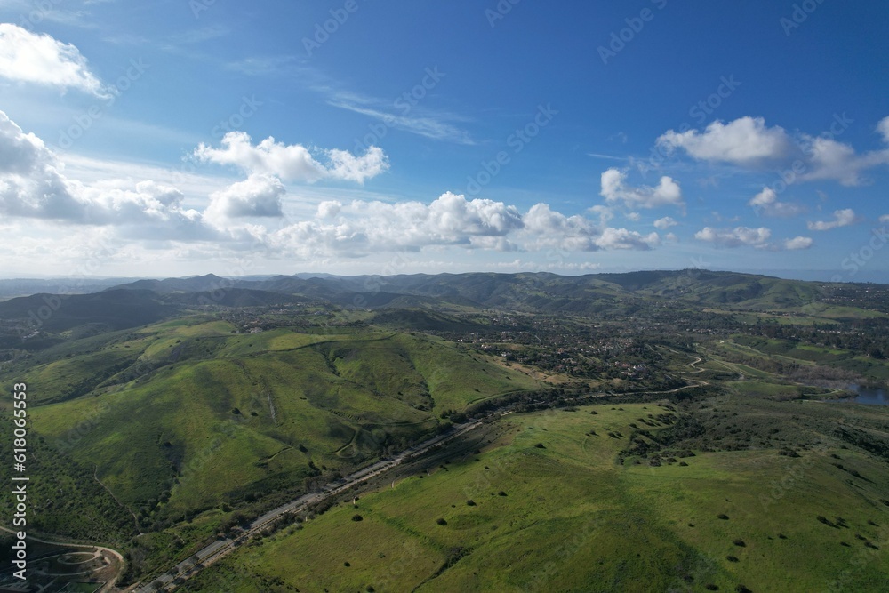 Aerial view of a green field in the hills