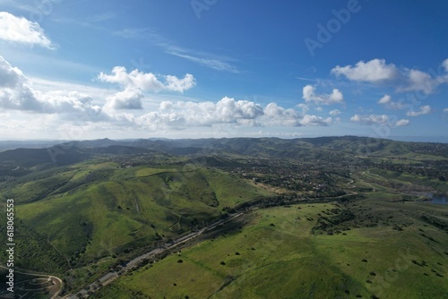 Aerial view of a green field in the hills