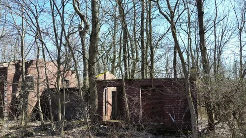 Red brick abandoned building surrounded by leafless trees in Centralia, Pennsylvania
