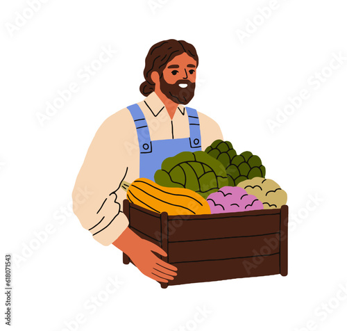Happy farmer holding fresh vegetables in crate. Agriculture worker with woode...