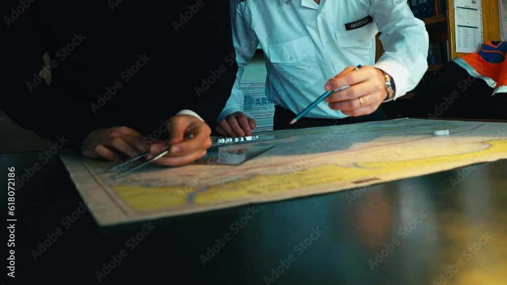 4K footage of planning a long trip on a freight ship. Captain and mate ...
