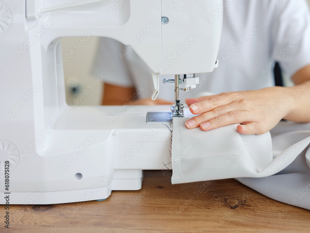 Fashion, fabric and sewing, woman at machine in small business with creative ideas and focus at home studio. Creativity, startup and design, tailor or designer stitching, young entrepreneur at work.