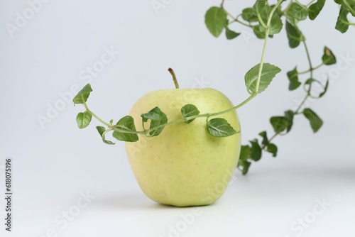 Ripe green apple with green leaves on the white backrgound