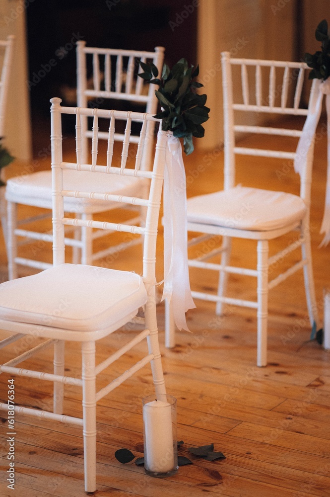Interior of wedding ceremony space with white chairs